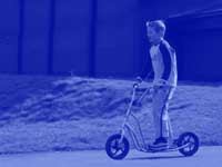 boy on scooter - point to screen - powerpoint backgrounds